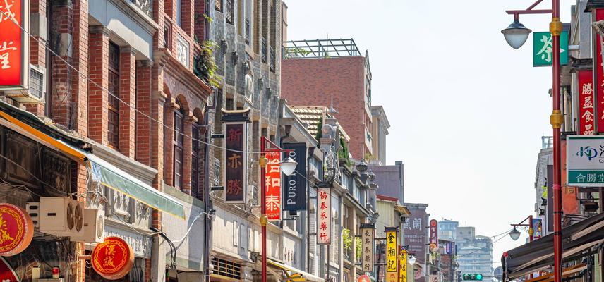 A view of a street in Taiwan, filled with colourful shop signs on either side